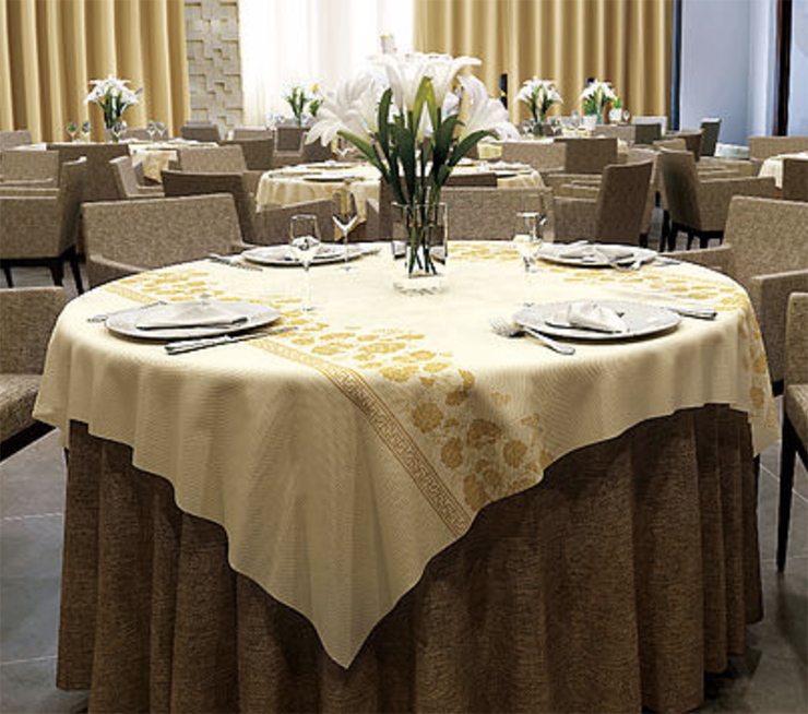 Add some small gold peony decorated plastic tablecloths to the restaurant from Sunshine Supply Company.